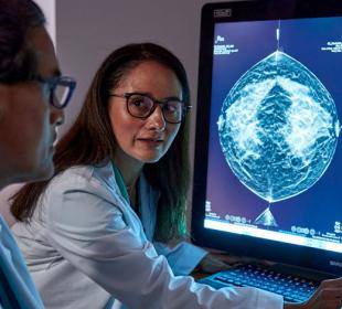 Providers reviewing x-ray on monitor in dark office setting